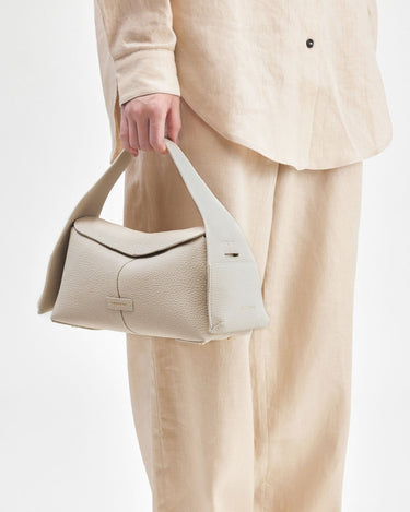 Small Drippy Roof Bag in Ivory, made from full-grain leather with a structured shape and a minimalist design.