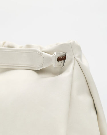 Close-up of the cream-colored Small Gather Bag Set, showcasing the textured leather and braided strap detail.