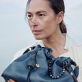 Navy Small Gather Bag Set made of full-grain nappa leather with decorative beaded straps and gold hardware.