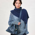 Navy Small Gather Bag Set with drawstring closure, worn by a model in a distressed sweater and dark jeans.