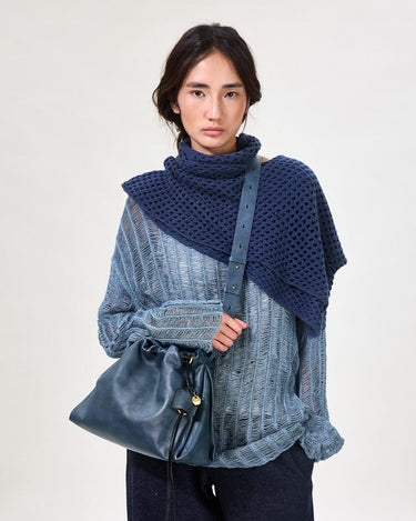Navy Small Gather Bag Set with drawstring closure, worn by a model in a distressed sweater and dark jeans.