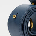 Navy small gather bag set in nappa leather with gold hardware, showcasing stitching and embossed logo detail.