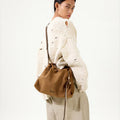 Ochre suede Small Gather Bag Set on woman wearing distressed sweater and linen pants