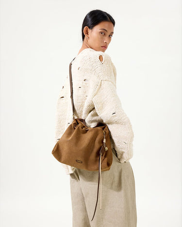 Ochre suede Small Gather Bag Set on woman wearing distressed sweater and linen pants
