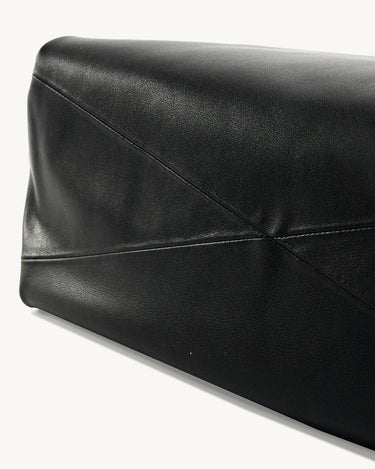 Close-up of black leather Small Gather Bag Set showing geometric stitching and textured finish.