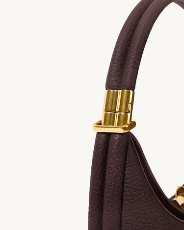 Small Luna Bag in burgundy full-grain leather with gold-tone hardware detail.