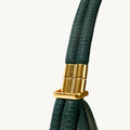 Small Luna Bag in emerald green textured leather with gold clasp detail, featuring Songmont logo.