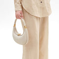 Ivory Small Luna Bag with gold hardware, textured leather, and crescent shape