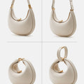 Ivory Small Luna Bag made of full-grain leather with gold hardware. Versatile design with multiple carrying options.