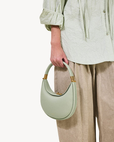 Small Luna Bag in Jade green pebble-grain leather with gold hardware details.