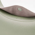 Close-up of the magnetic closure on the Small Luna Bag in Jade, showcasing textured full-grain leather.
