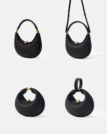 Small Luna Bag in Onyx black full-grain leather, showcasing versatile carrying styles with gold hardware.