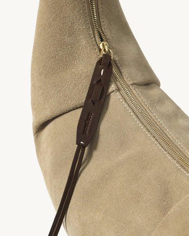 Medium Luna Hobo Bag in Dune Suede with gold zipper and debossed "Songmont" leather pull.