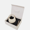 Small Luna bag in ivory full-grain leather with a pet leash in cream apricot, presented in a gift box.