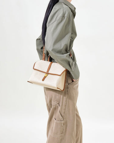 Small Shan Satchel Bag in Canvas with leather trim, featuring a gold buckle closure. Perfect for everyday wear.
