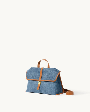 Small Shan Satchel Bag in denim with tan leather trim and strap.