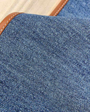 Blue denim Small Shan Satchel Bag with brown leather trim and visible stitching.