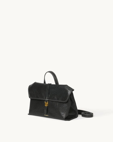 Black Small Shan Satchel Bag in vegetable-tanned leather with gold buckle and white stitching