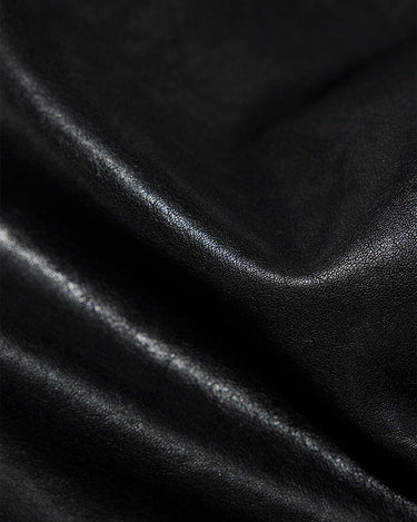 Close-up of black vegetable-tanned leather texture for the Small Shan Satchel Bag.