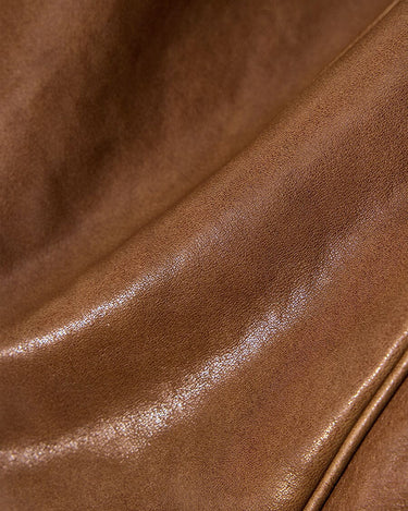 Close-up texture of brown vegetable-tanned leather, Small Shan Satchel Bag in Sandal color.