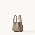 Small taupe full-grain leather Song Bag with magnetic closure and gold feet