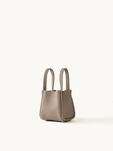 Small taupe full-grain leather Song Bag with magnetic closure and gold feet