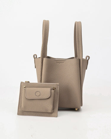 Small Song Bag in taupe, made from full-grain leather, with a matching leather pouch.