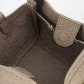 Interior of taupe Small Song Bag: full-grain leather, single compartment, magnetic closure.