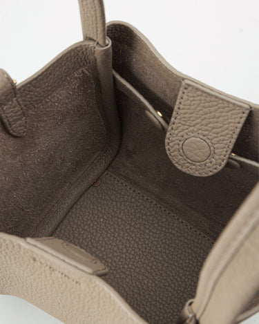 Interior of taupe Small Song Bag: full-grain leather, single compartment, magnetic closure.