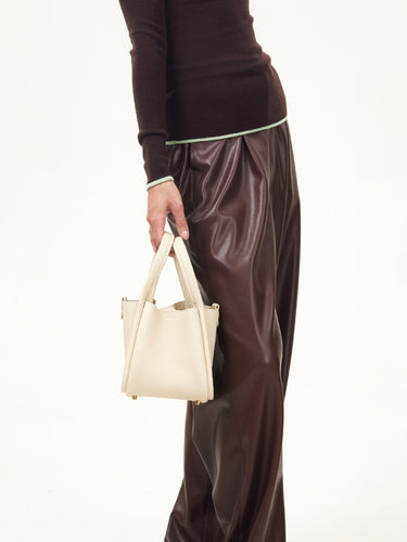 Small off-white full-grain leather song bag with magnetic closure and gold feet.