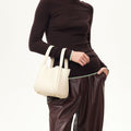 Cream full-grain leather Small Song Bag with gold hardware and magnetic closure.