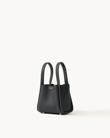 Small black full-grain leather Song bag with top handles and magnetic closure.