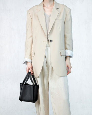 Black full-grain leather Small Song Bag with top handles and magnetic closure.