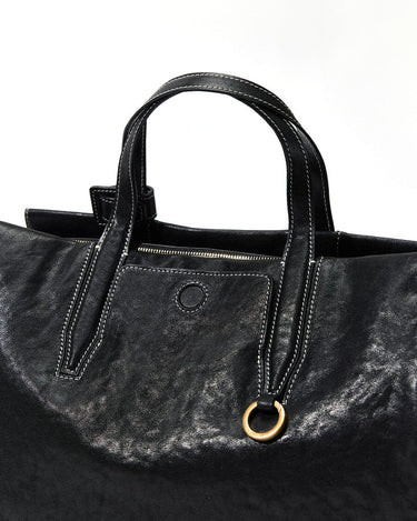 Black Small Yore Duffle Bag: textured leather, white stitching, brass hardware. Songmont travel bag.