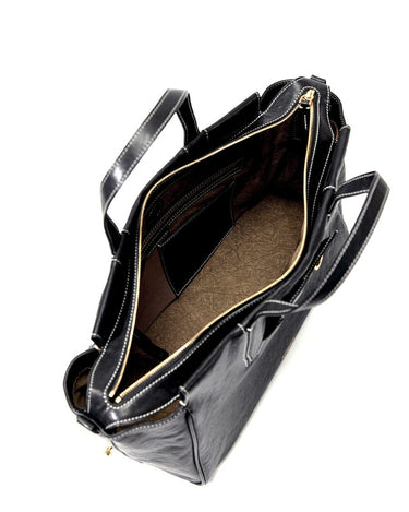 Small Yore Duffle Bag in Onyx, black leather with white stitching, open interior compartments, gold zipper.