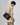 Small Yore Duffle Bag in Onyx, a textured black leather bag with white stitching worn over the shoulder.