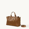 Small Yore Duffle Bag in Sandal color, made from vegetable-tanned leather with adjustable strap.