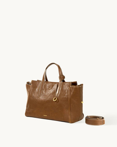 Small Yore Duffle Bag in Sandal color, made from vegetable-tanned leather with adjustable strap.