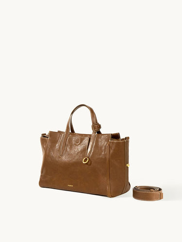 Small Yore Duffle Bag in Sandal color, made from vegetable-tanned leather with adjustable strap.