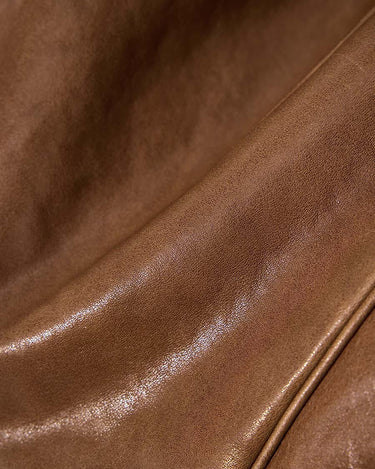 Close-up of Sandal colored vegetable-tanned leather on Small Yore Duffle Bag, showing texture and sheen.