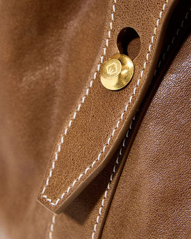 Sandal leather Small Yore Duffle Bag with white stitching and gold emblem detail.
