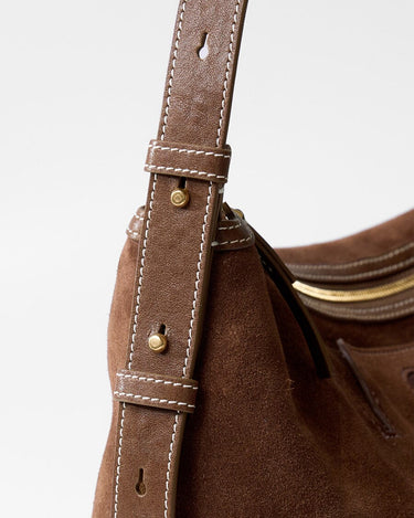 Small Yore Hobo Bag minimal version in Sandal Suede, showing leather strap with white stitching and gold hardware.