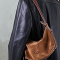 Sandal Suede Small Yore Hobo Bag: Minimalist suede hobo with adjustable strap, complementing a black leather jacket.
