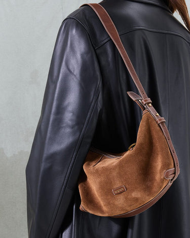 Sandal Suede Small Yore Hobo Bag: Minimalist suede hobo with adjustable strap, complementing a black leather jacket.