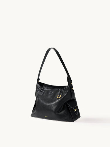 Small Yore Hobo Bag in Onyx: Vegetable-tanned leather with white stitching and gold hardware.