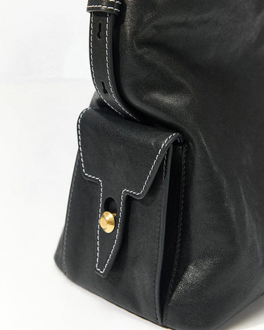 Small Yore Hobo Bag in Onyx black vegetable-tanned leather with white stitching and gold hardware.