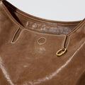 Small Yore Hobo Bag in Sandal color, featuring vegetable-tanned leather, brass hardware, and white stitching.
