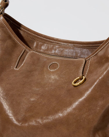 Small Yore Hobo Bag in Sandal color, featuring vegetable-tanned leather, brass hardware, and white stitching.