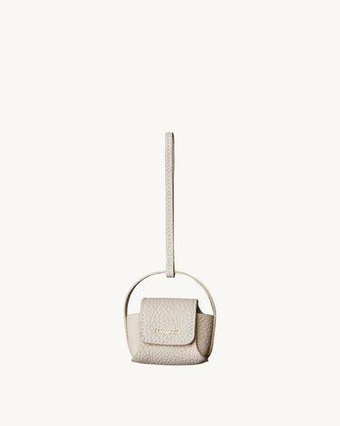Songmont off-white full-grain leather AirPods case with magnetic closure and handle