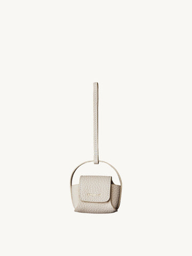 Songmont off-white full-grain leather AirPods case with magnetic closure and handle